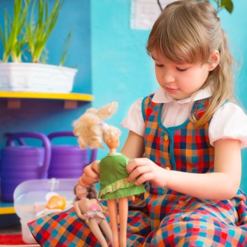 girl playing with dolls identity theft
